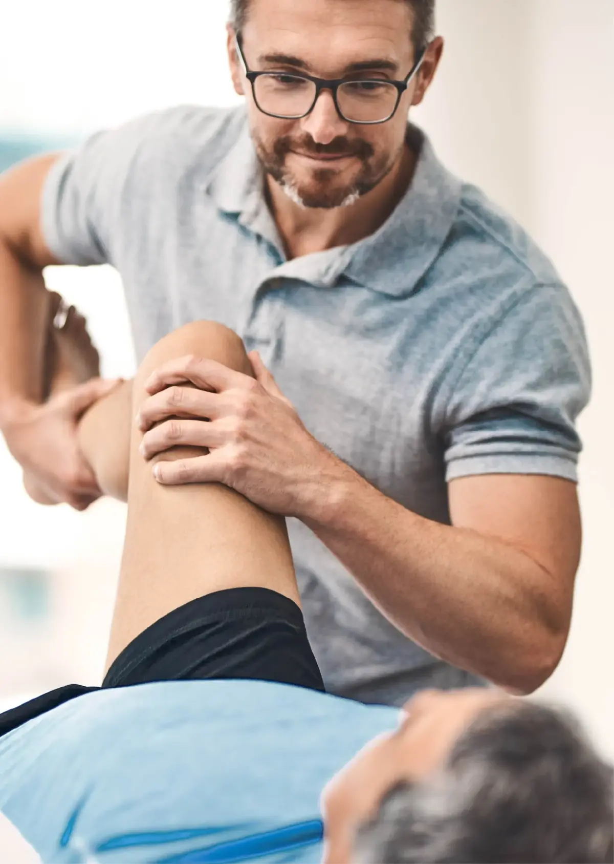 Therapist helping a patient with knee strengthening exercises